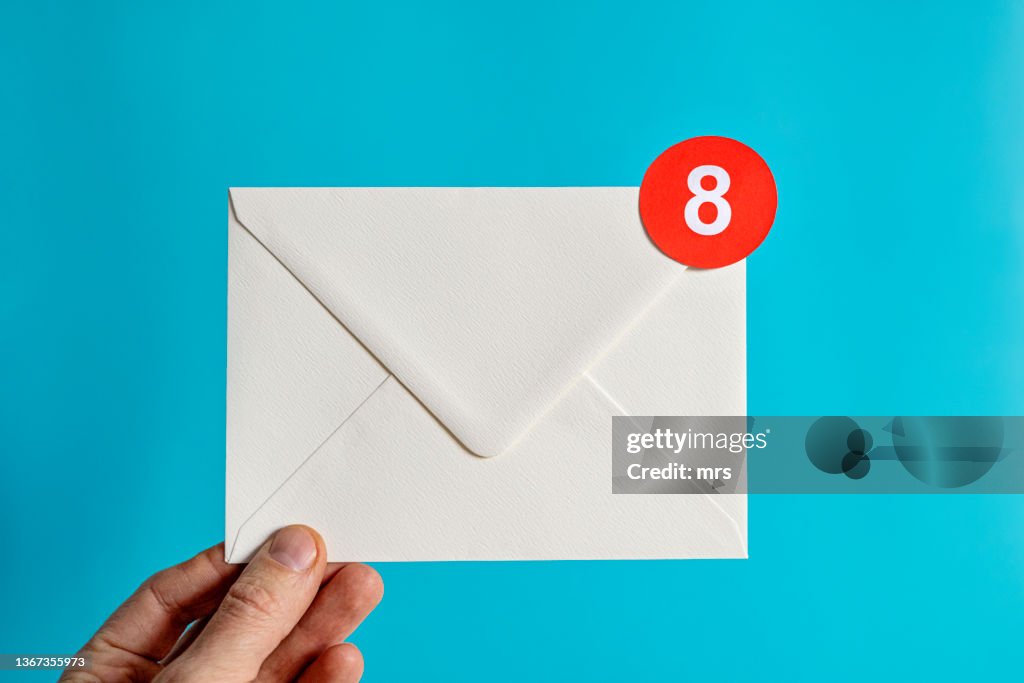 Hand holding white envelope with notification-Email concept