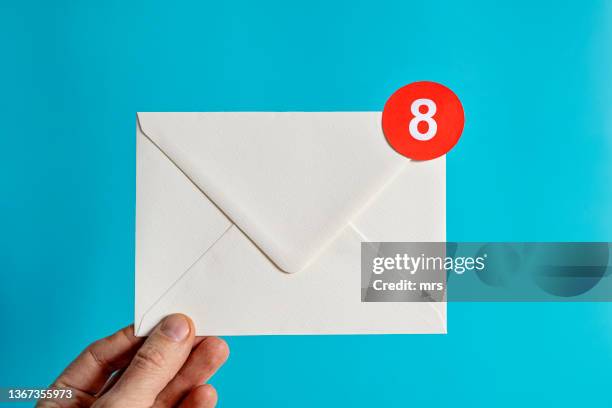 hand holding white envelope with notification-email concept - receiving email stock pictures, royalty-free photos & images