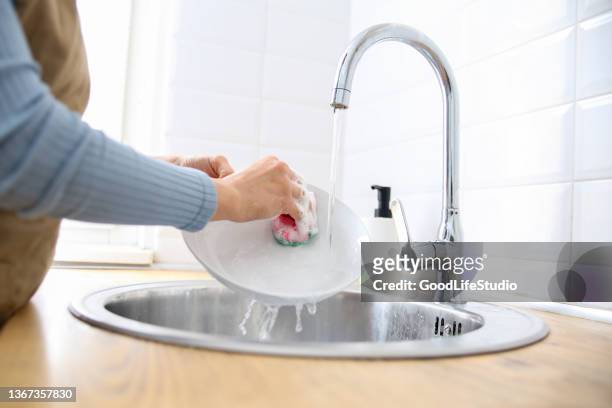 washing a plate - wash the dishes stock pictures, royalty-free photos & images