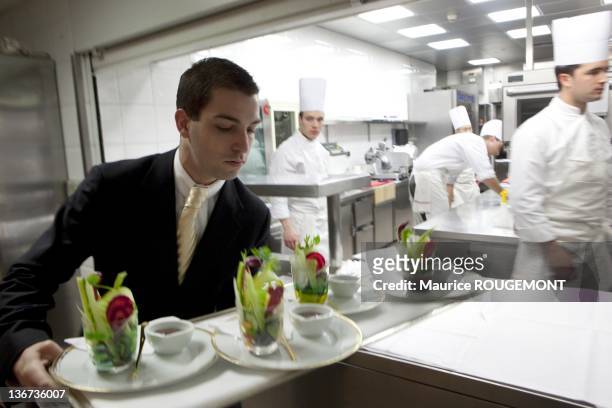 Waiter taking the dishes to the dining room at the Restaurant Louis XV at the Hotel de Paris on March 3, 2011 in Monaco. The Louis XV is overheaded...
