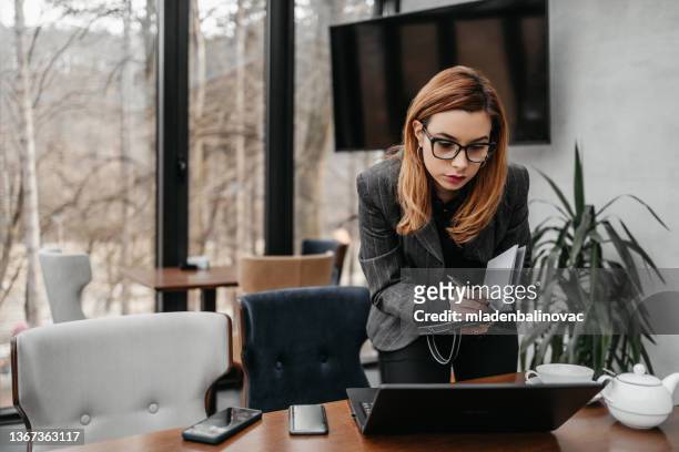 attractive and positive business woman working in modern office. - workers compensation stock pictures, royalty-free photos & images