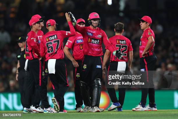 Jay Lenton of the Sixers celebrates with team mates during the Men's Big Bash League match between the Perth Scorchers and the Sydney Sixers at...