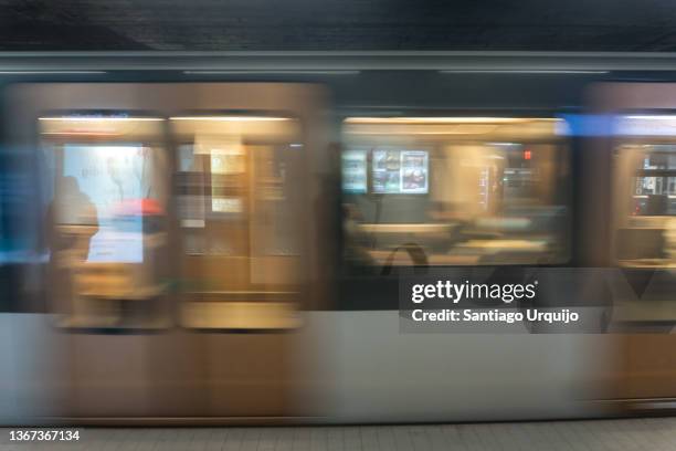 metro traversing the schuman subway station - underground rail stock pictures, royalty-free photos & images