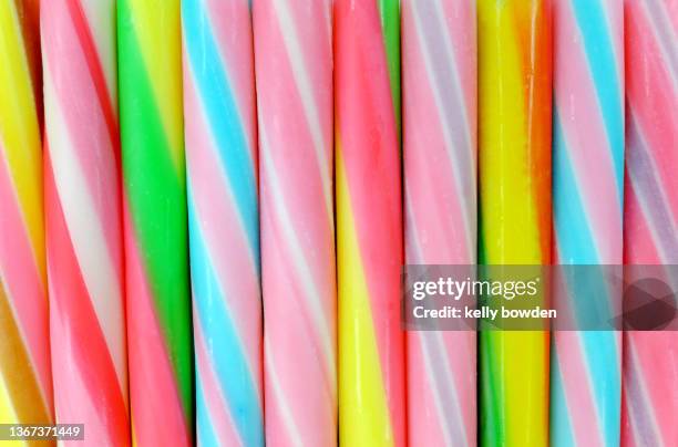 summer stick of rock rainbow seaside candy sweets - boiled sweet stock pictures, royalty-free photos & images