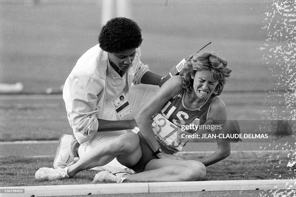 Mary Decker of the USA, comforted by a t