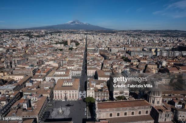 An aerial view of the city of Catania with the volcano Etna in the background. Below Piazza Duomo on January 28, 2022 in Catania, Italy. Catania is...