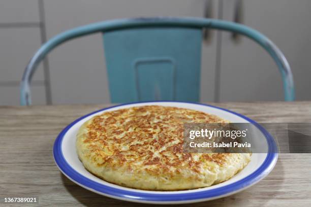 spanish omelette on kitchen table - frittata stock pictures, royalty-free photos & images