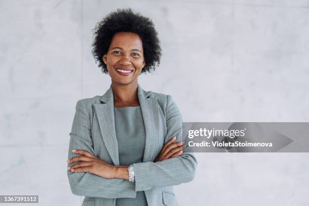 portrait of a smiling young businesswoman. - woman in black suit stock pictures, royalty-free photos & images