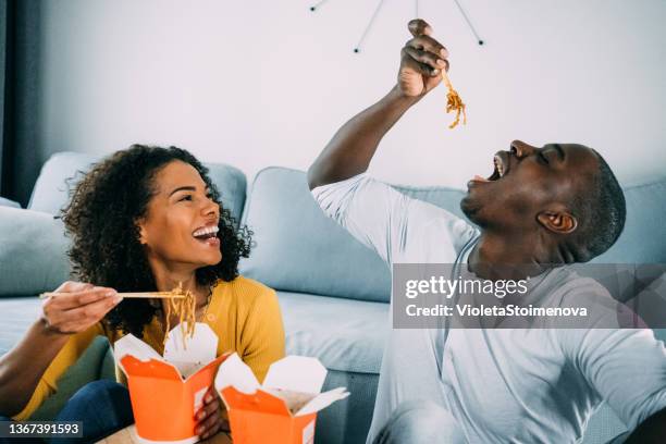 happy couple eating chinese food at home. - take out food imagens e fotografias de stock