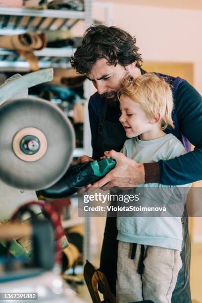 shoemaker and his cute little boy in the workshop. - polishing shoes stock pictures, royalty-free photos & images