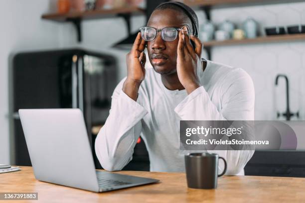 stressed businessman using laptop at home. - long haul stock pictures, royalty-free photos & images