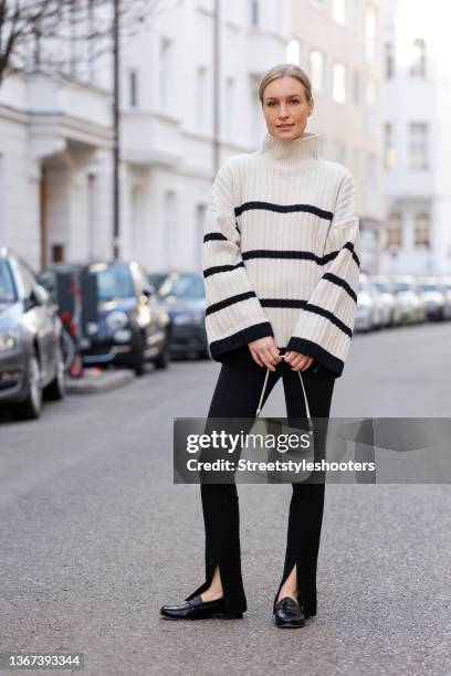 Influencer and model Marlies Pia Pfeifhofer wearing a white knitted turtleneck pullover with black stripes by H&M, leggings with slits by by Mango,...