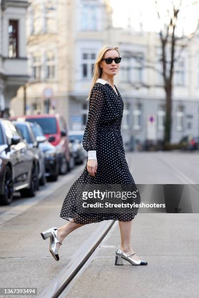 Influencer and model Marlies Pia Pfeifhofer wearing a black dress with white polka dots by Zara, wayfarer sunglasses by Ray-Ban, a white bag with...