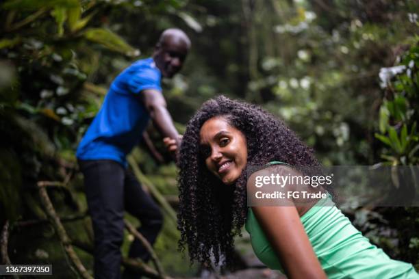 portrait of young woman hiking in the forest - eco tourism stock pictures, royalty-free photos & images