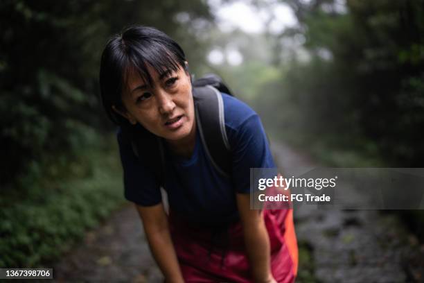 tired mature woman in the forest - ontsnappen stockfoto's en -beelden