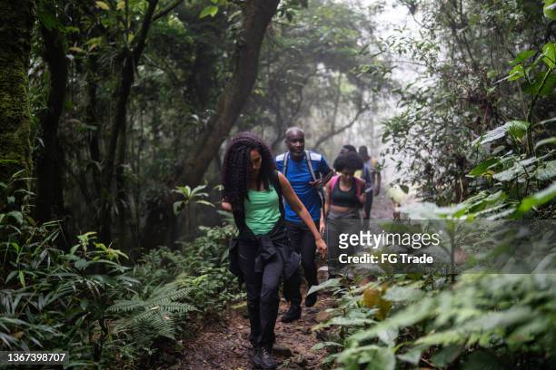 friends hiking in the forest - person of color stock pictures, royalty-free photos & images