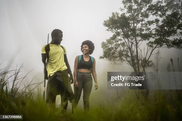 young friends hiking in the forest - eco tourism stock pictures, royalty-free photos & images