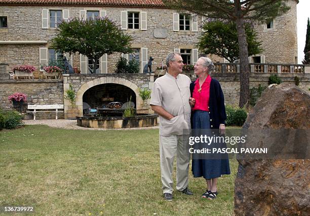 Queen Margrethe II of Denmark poses 08 August 2002 with her husband, Prince Consort Henrik, at the Caïx castle near the southwestern French city of...