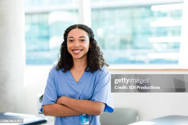 young adult nursing student poses for photo with arms crossed - physiotherapist bildbanksfoton och bilder