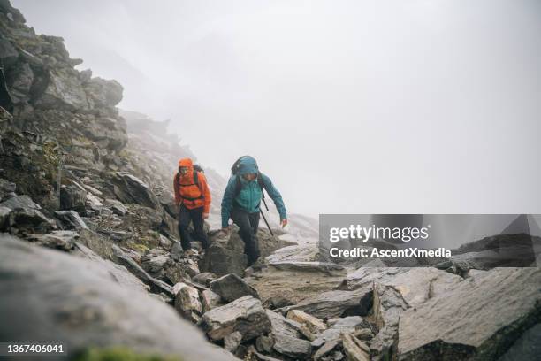 mountaineers scramble up a rocky ridge - scrambling bildbanksfoton och bilder