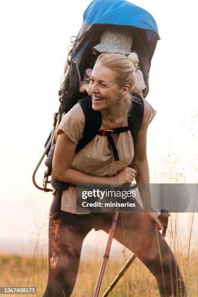 beautiful cheerful woman hiking with her baby - 40s couple sunny stock pictures, royalty-free photos & images