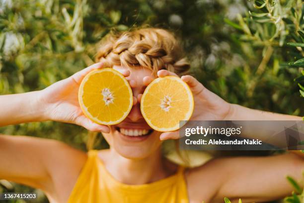 oranges in her eyes - citrus fruit stock pictures, royalty-free photos & images