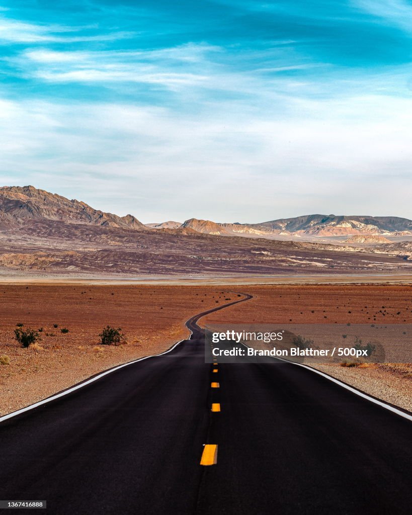 Empty road along landscape against sky,Inyo County,California,United States,USA