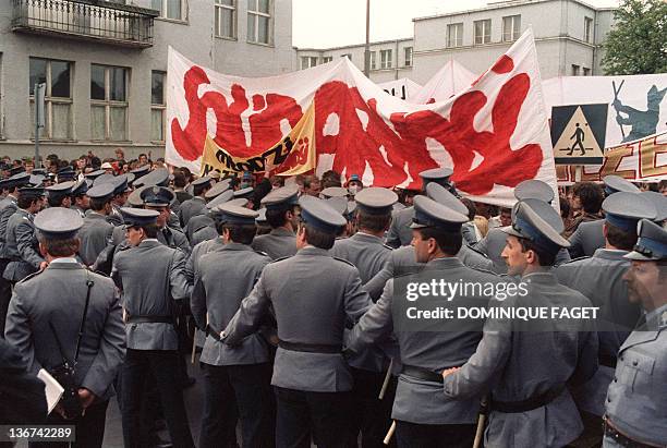 Polish policemen block the members of the outlawed Solidarity trade union during a rally 12 June 1987 in Zaspa, near Gdansk, north of Poland, after...