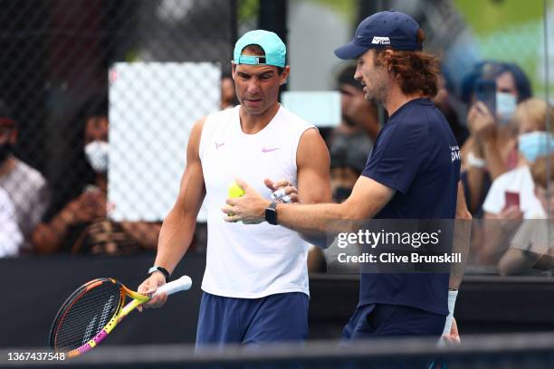 Rafael Nadal of Spain speaks to his coach Carlos Moya during a practice session during day 13 of the 2022 Australian Open at Melbourne Park on...