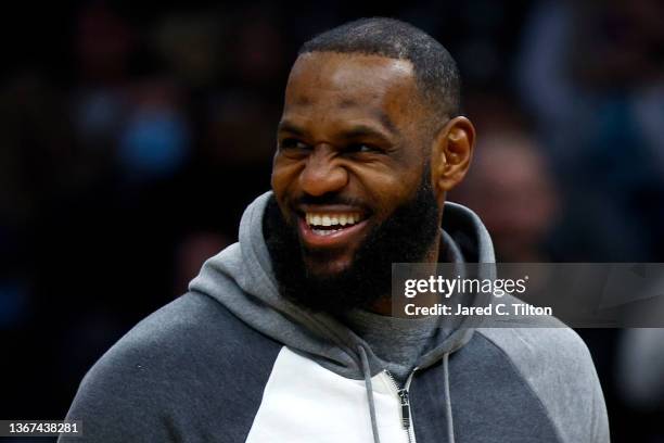 LeBron James of the Los Angeles Lakers looks on from the sideline during the first half of the game against the Charlotte Hornets at Spectrum Center...