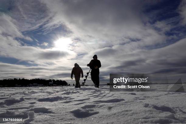 Volunteers drill holes through the ice on Gull Lake in preparation for Brainerd Jaycees Ice Fishing Extravaganza on January 28, 2022 in Brainerd,...