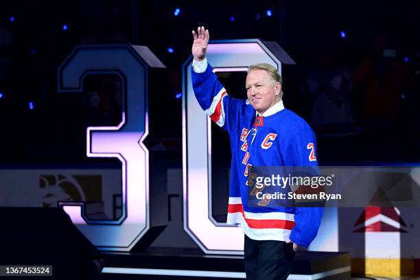 Former New York Rangers player Brian Leetch waves to fans during Henrik Lundqvist's jersey retirement ceremony prior to a game between the New York...