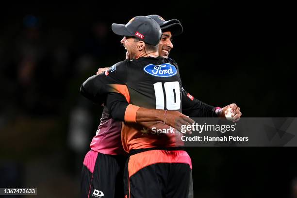 Joe Walker of the Northern Brave celebrates the wicket of Cam Fletcher of the Canterbury Kings with Jeet Raval during the Super Smash domestic...