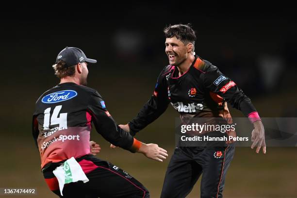 Joe Walker of the Northern Brave celebrates the wicket of Mitch Hay of the Canterbury Kings with Henry Cooper of the Northern Brave during the Super...