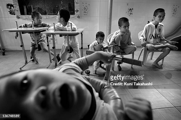 Children that suffer from mental and physical disabilities are seen at the Thien Phuoc Center for Handicapped Children on July 7, 2009 in Ho Chi Minh...