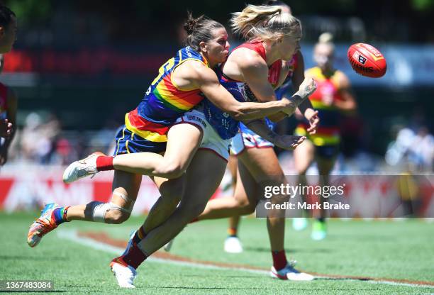 Tyla Hanks of the Demons handballs tackled by Chelsea Randall of the Adelaide Crows during the round four AFLW match between the Adelaide Crows and...