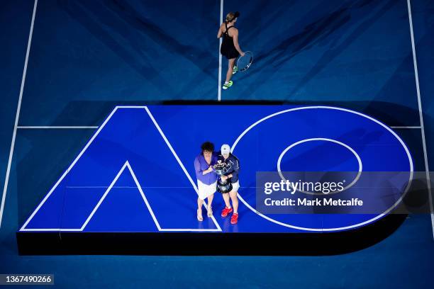 Ashleigh Barty of Australia poses with Evonne Goolagong Cawley as Danielle Collins of United States leaves the stage during the trophy presentation...