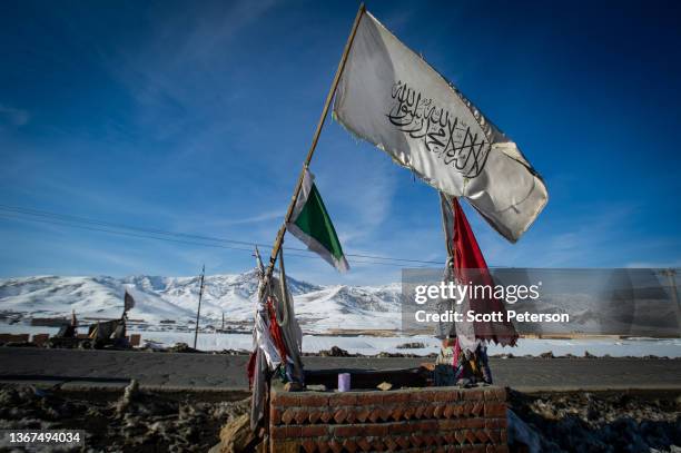 Flags fly as Afghans in Wardak province, which witnessed frequent fighting during the Taliban insurgency, live among the snow-covered remnants of war...