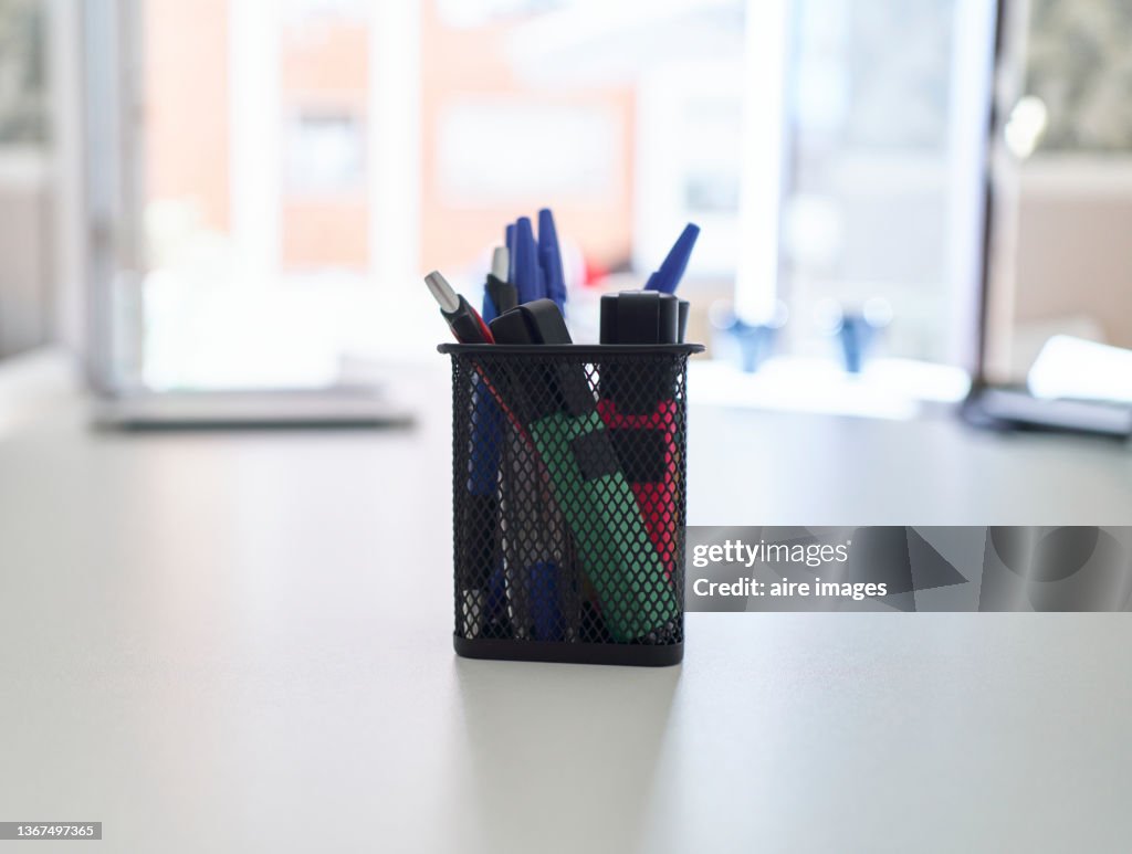 Close-Up Of Pencils and markers In Desk Organizer On Table