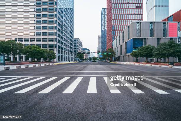 empty city street in financial district - zebra crossing low angle stock pictures, royalty-free photos & images