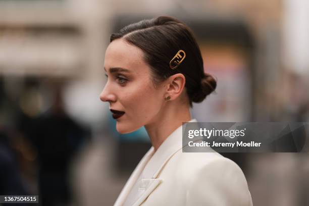 Mary Leest wears a white latte V-neck blazer jacket from Fendi, a white latte leather small belt with gold buckle from Fendi, a matching white latte...