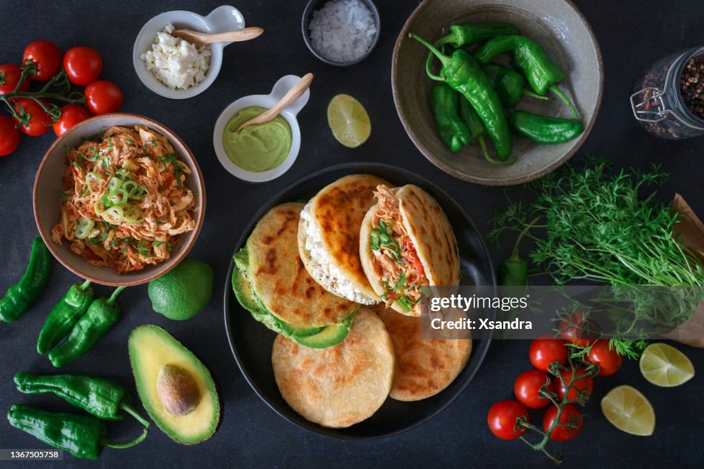 Arepa with chicken meat, cheese and avocado - traditional Colombian food