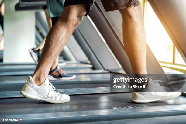 young athletic man running on treadmill legs close up - beautiful male feet stock pictures, royalty-free photos & images