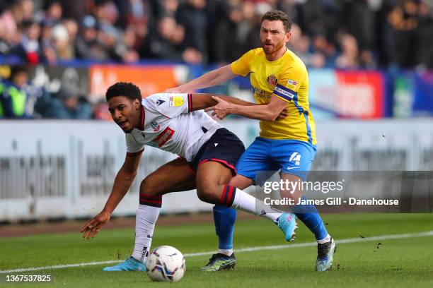 Corry Evans of Sunderland battles for possession with Oladapo Afolayan of Bolton Wanderers during the Sky Bet League One match between Bolton...