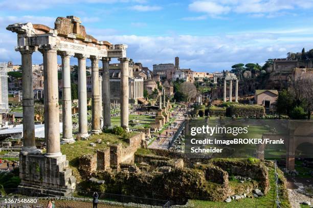 view of ruins with columns and remains of foundations of temple of saturn, behind basilica julia basilica iulia, roman forum, latium, italy - foro romano foto e immagini stock