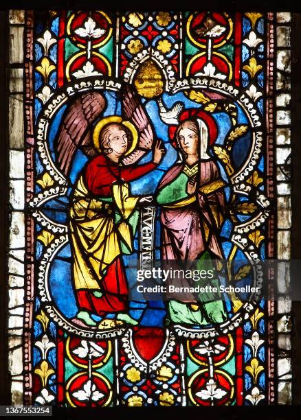 the annunciation scene represented on medieval stained glass window - stained glass angel stock pictures, royalty-free photos & images