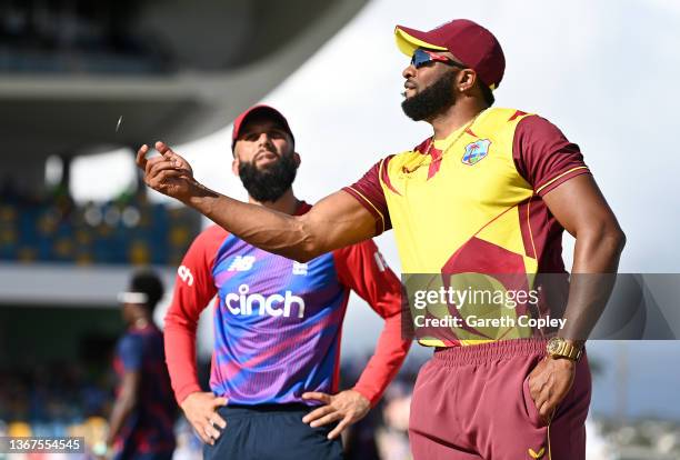 Kieron Pollard of West Indies flips the coin as Moeen Ali of England looks on ahead of the T20 International Series Fourth T20I match between West...