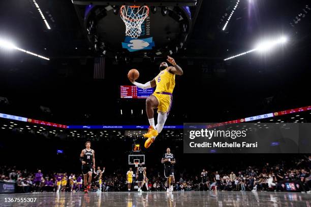 LeBron James of the Los Angeles Lakers dunks against the Brooklyn Nets during their Chinese New Year celebration at Barclays Center on January 25,...