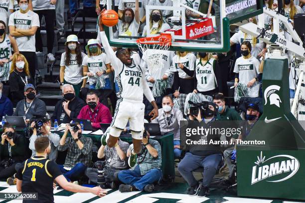 Gabe Brown of the Michigan State Spartans dunks the ball during the second half of a college basketball game against the Michigan Wolverines at...