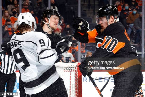 Adrian Kempe of the Los Angeles Kings tangles with Travis Sanheim and Rasmus Ristolainen of the Philadelphia Flyers during the third period at Wells...